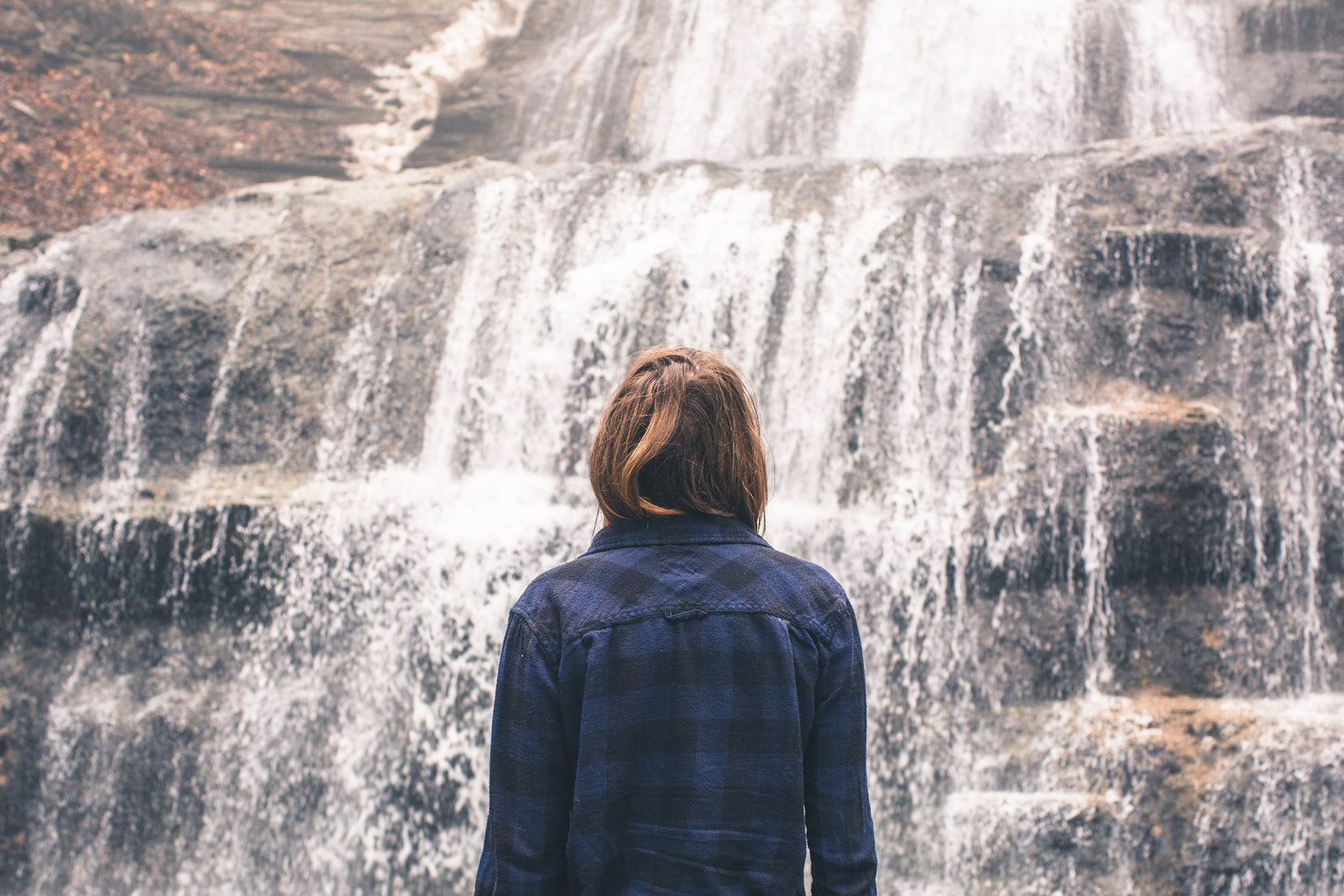 Woman looking at a waterfall